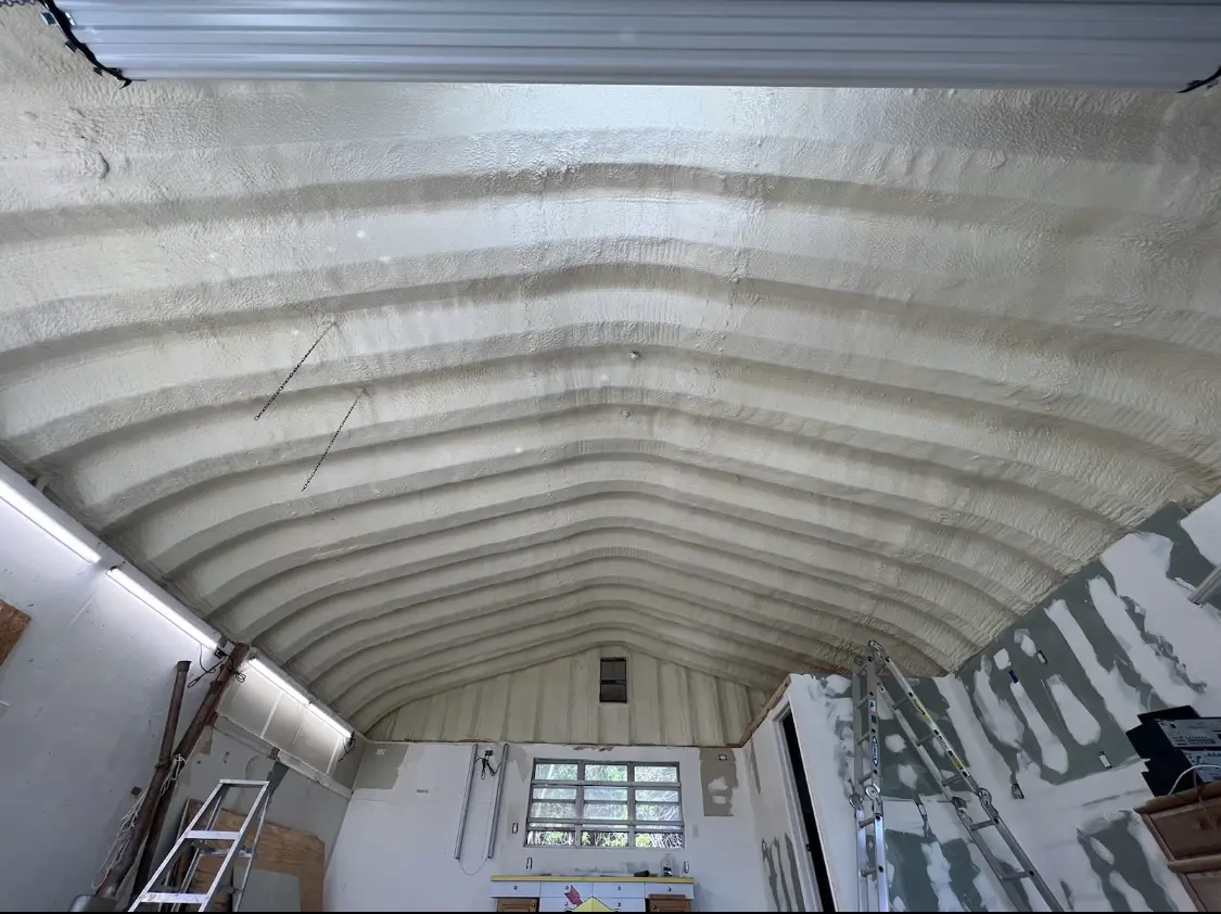 Spray polyurethane foam applied to the underside of a metal roof deck in Florence
